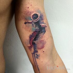 Tattoo Watercolor astronaut on the upper arm motif: characters style: Watercolor
