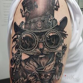 Tattoo Kitten with a hat on the upper arm motif: characters style: graphic / illustrative