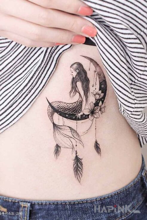 Tattoo Syrena in black and gray motif and graphic / illustrative style on the ribs