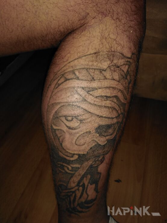 Tattoo Kostucha in black and gray motif and graphic / illustrative style on the calf
