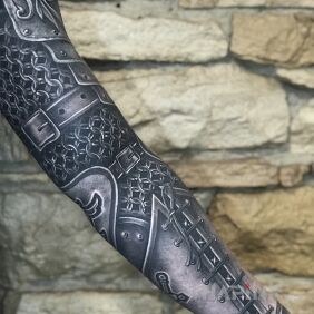 Tattoo Skin as tough as steel on the upper arm motif: other style: realistic
