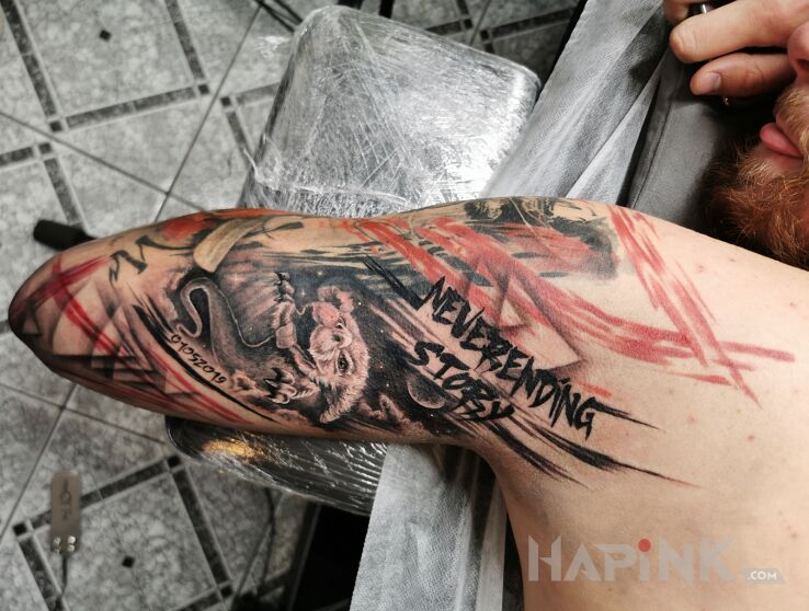 Tattoo The never-ending story in dragons motif and trash polka style on the upper arm