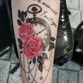 Tattoo Clock Roses on the forearm motif: lettering style: realistic