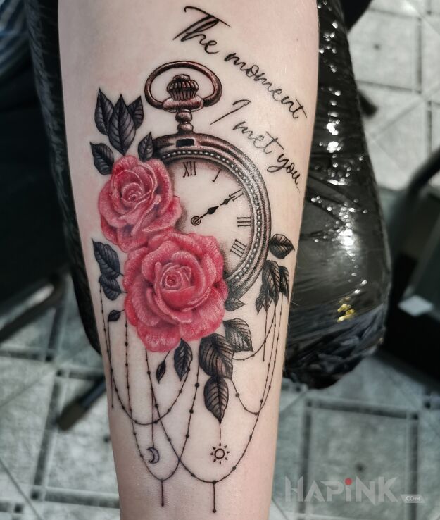 Tattoo Clock Roses in objects motif and calligraphy style on the forearm