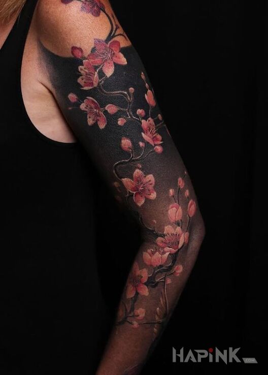 Tattoo Kwiat wiśni in colorful motif and realistic style on the forearm