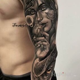 Tattoo A light smile from behind the leaves on the forearm motif: faces style: realistic
