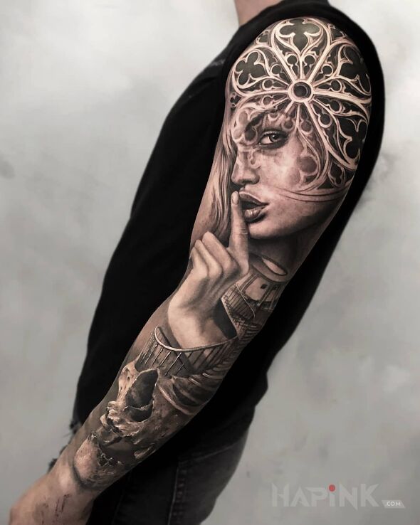 Tattoo Palec na ustach in black and gray motif and realistic style on the upper arm