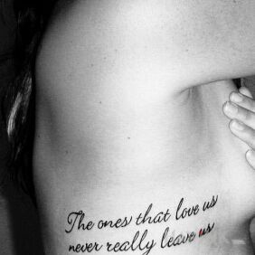 Tattoo Those who love us on the ribs motif: lettering style: calligraphy