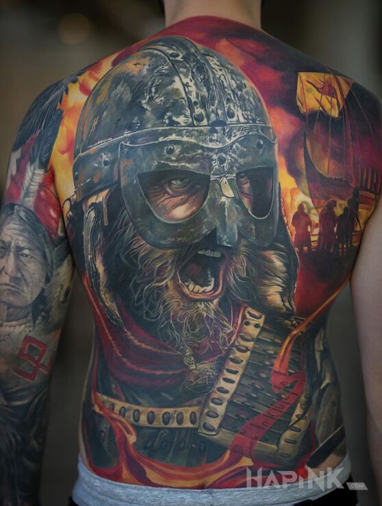 Tattoo Okrzyk wikinga in faces motif and realistic style on the upper arm