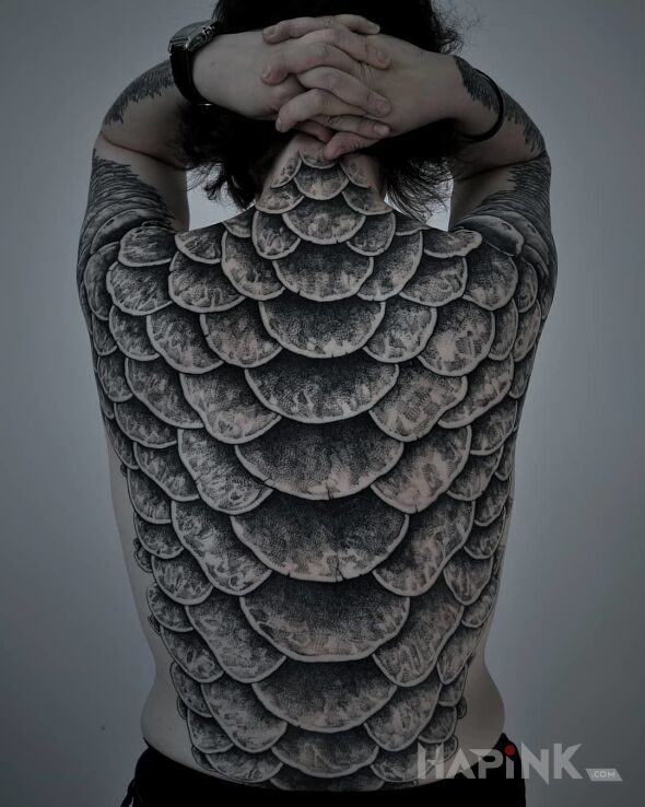 Tattoo Łuski in black and gray motif and realistic style on the shoulder blades