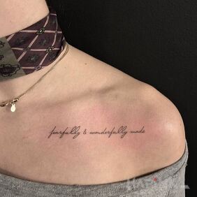 Tattoo Fearfully and wonderfully made on the collarbone motif: lettering style: calligraphy