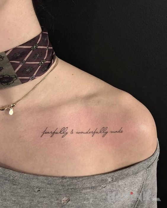 Tattoo Fearfully and wonderfully made in lettering motif and calligraphy style on the collarbone