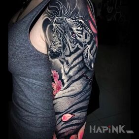 Tattoo White tiger on the upper arm motif: flowers style: realistic