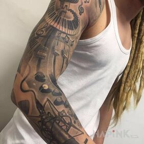 Tattoo Music on the upper arm motif: sleeves style: realistic