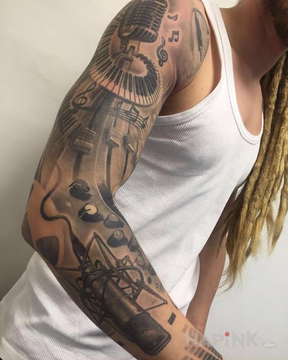 Tattoo Muzyka in objects motif and realistic style on the upper arm