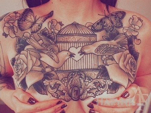 Tattoo Ptaszki i motylki in flowers motif on the breast