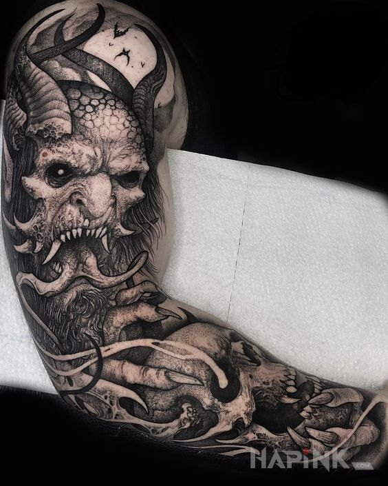 Tattoo Diabel na rece in dark motif and graphic / illustrative style on the upper arm