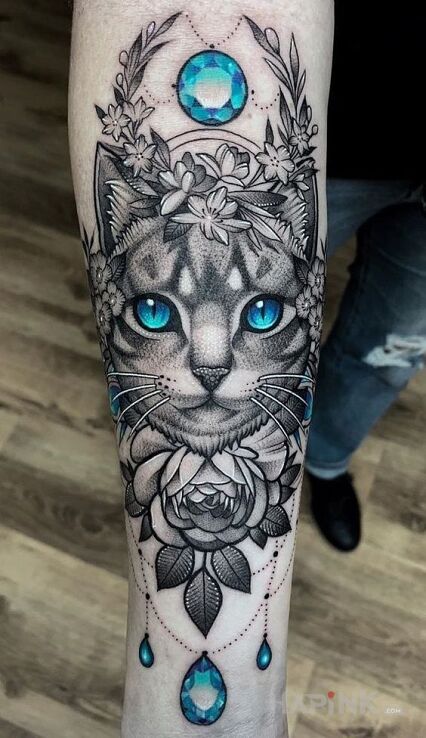 Tattoo Magiczny kot in ornaments motif and realistic style on the forearm