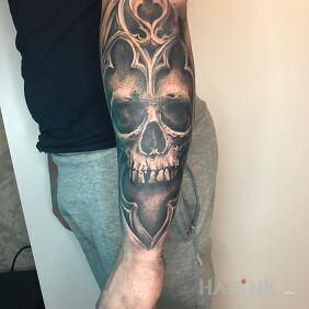Tattoo Skull with ornaments on the forearm motif: Stained glass style: realistic