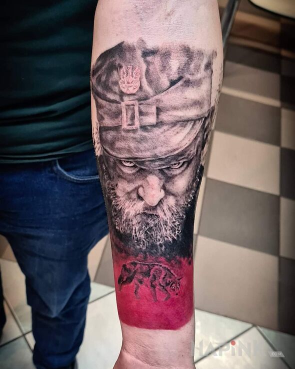 Tattoo Hubal in animals motif and realistic style on the forearm