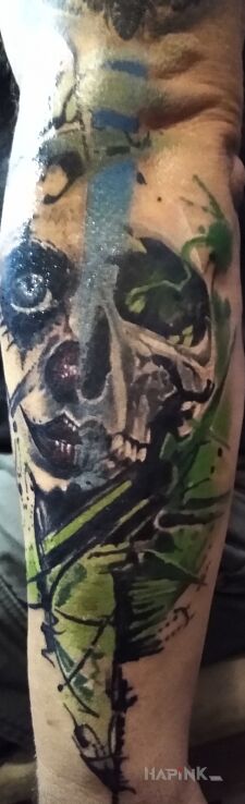 Tattoo Czaszka i klaun in skulls motif and abstract style on the forearm
