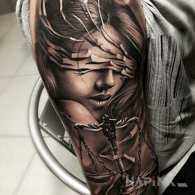 Tattoo Temida on the upper arm motif: faces style: realistic