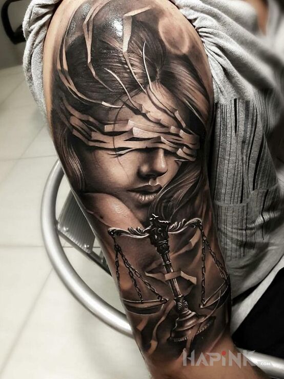 Tattoo Temida in black and gray motif and realistic style on the upper arm
