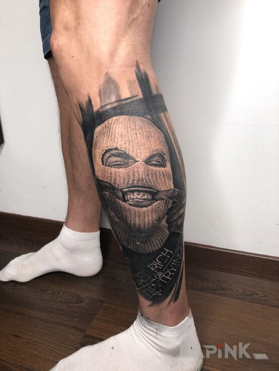 Tattoo Wesołek w kominie in black and gray motif and realistic style on the calf