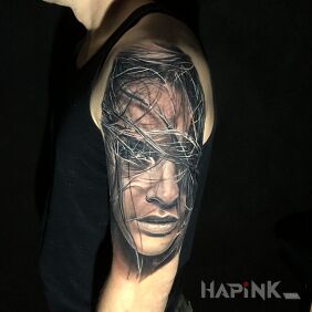 Tattoo Portrait of a girl on the upper arm motif: black and gray style: realistic