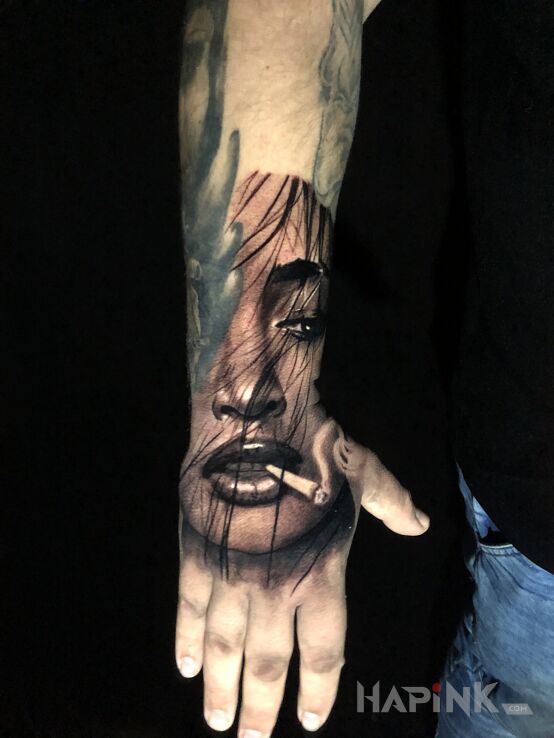 Tattoo Dziewczyna ze spliffem in faces motif and realistic style on the hand