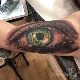 Tattoo Eye on the biceps on the upper arm motif: black and gray style: realistic