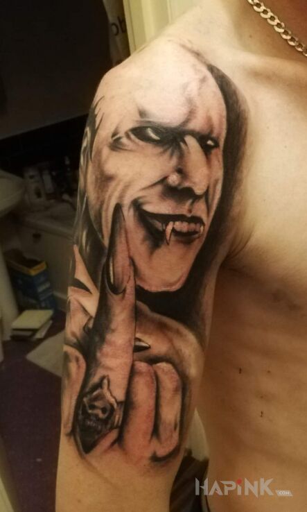 Tattoo Mieszany in black and gray motif and realistic style on the upper arm