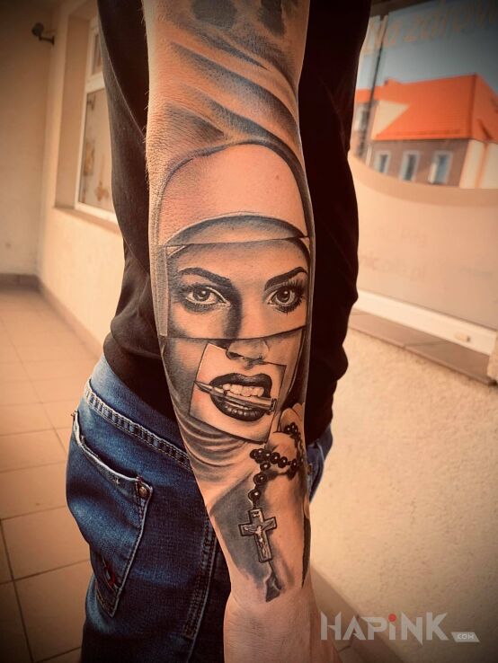 Tattoo Zakonnica in religious motif and realistic style on the forearm