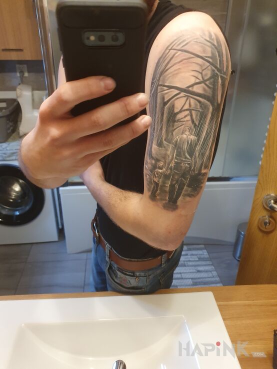 Tattoo Ojciec i syn in black and gray motif and realistic style on the upper arm
