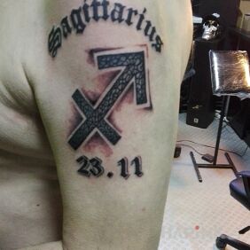 Tattoo Sagittarius (infinite) on the upper arm motif: lettering style: calligraphy