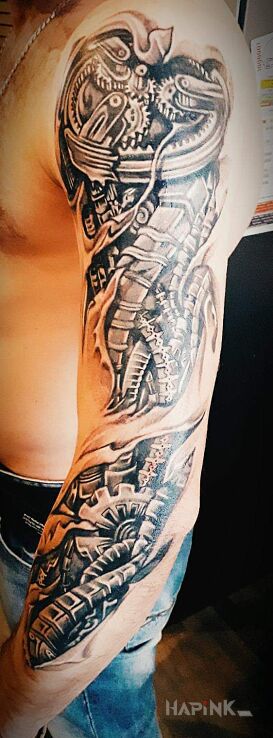 Tattoo Pierwszy ? in sleeves motif and biomechanics style on the upper arm