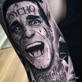 Tattoo Christian Bale - Psycho on the upper arm motif: black and gray style: realistic