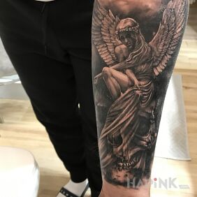 Tattoo Between life and death on the forearm motif: wings style: realistic
