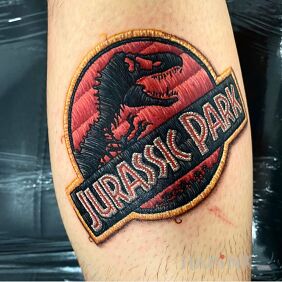 Tattoo Jurassic Park on the calf motif: colorful style: embroidered