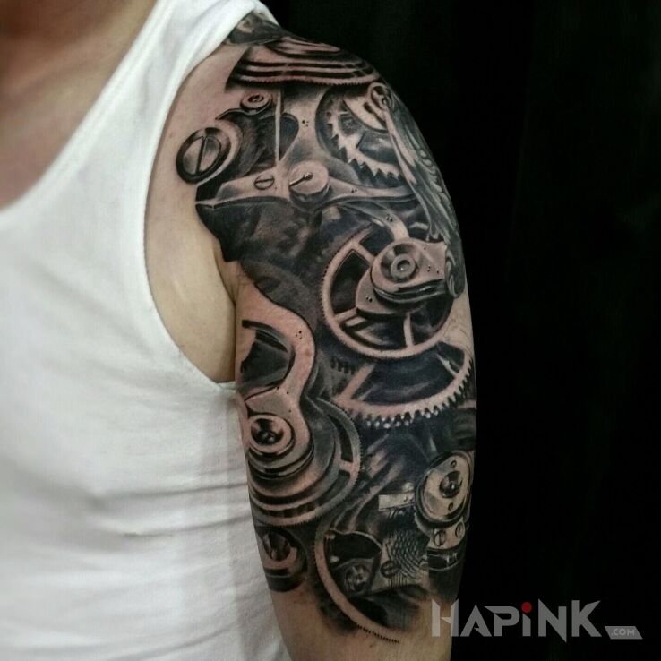 Tattoo Mechanizm in black and gray motif and biomechanics style on the upper arm