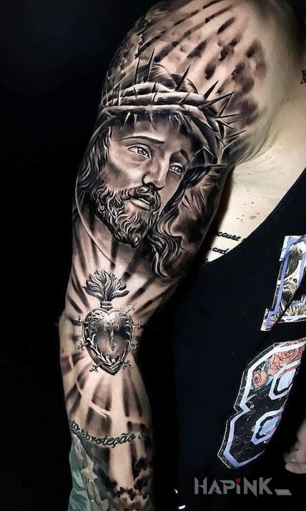 Tattoo Jezus in religious motif and realistic style on the upper arm