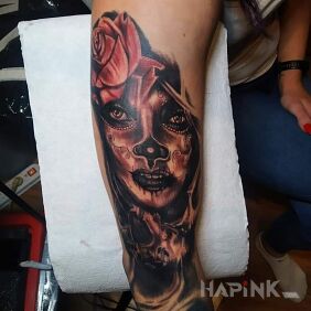Tattoo La catrina on the upper arm motif: faces style: realistic
