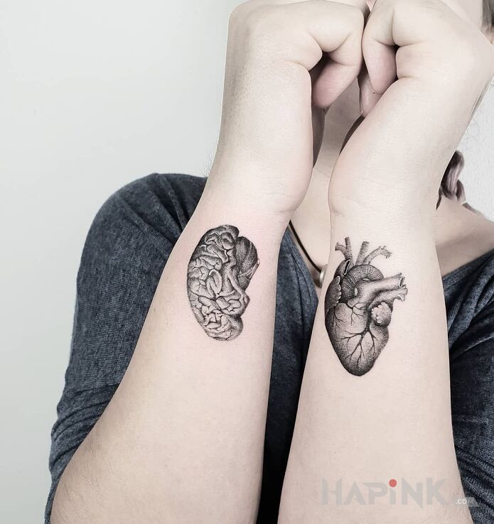 Tattoo Serce i rozum in black and gray motif and realistic style on the forearm