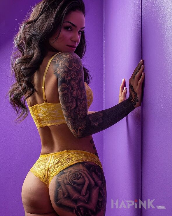 Tattoo Latina girl in sexy motif and realistic style on the upper arm