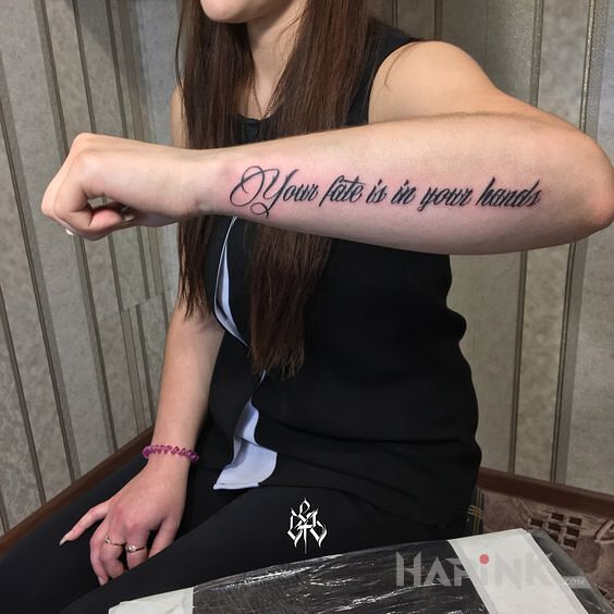 Tattoo Weź swój los w swoje ręce in lettering motif and calligraphy style on the forearm