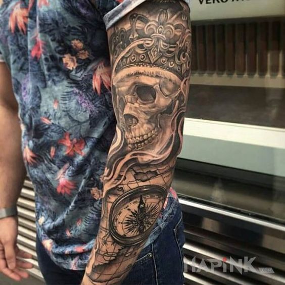 Tattoo Krol tyle ze martwy :) in black and gray motif and realistic style on the upper arm