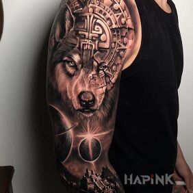 Tattoo Aztec wolf on the upper arm motif: black and gray style: realistic