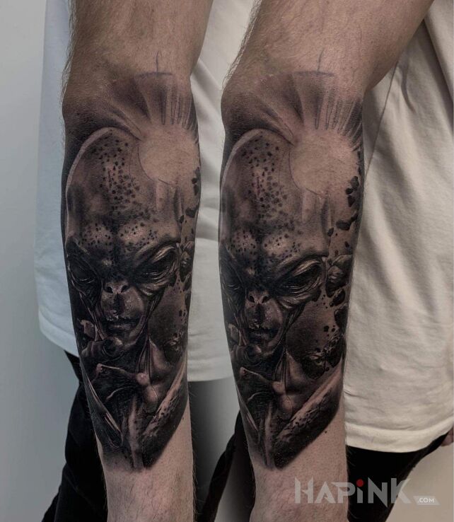 Tattoo Alien in cosmos motif and realistic style on the forearm