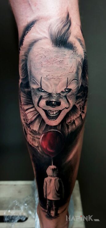 Tattoo Pennywise in faces motif and realistic style on the calf