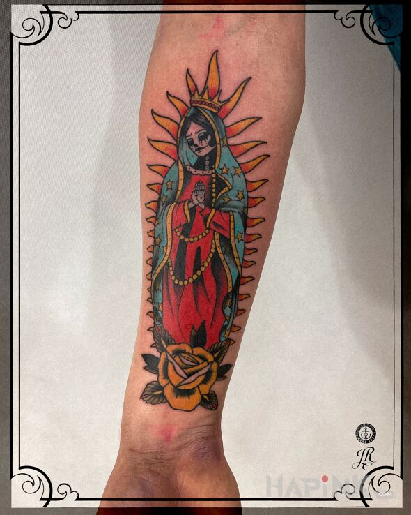 Tattoo Santa Muerte in flowers motif and oldschool style on the forearm